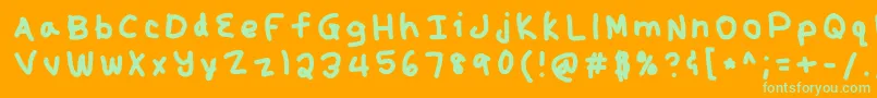 Kunal-Schriftart – Grüne Schriften auf orangefarbenem Hintergrund