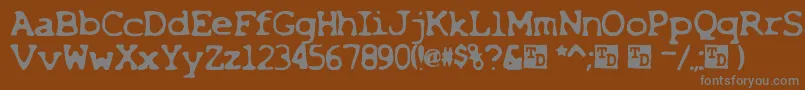 X-fontti – harmaat kirjasimet ruskealla taustalla