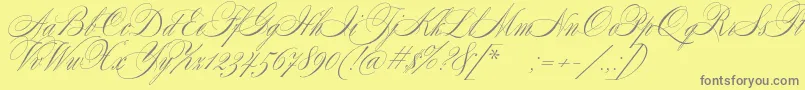 SplendidScript-fontti – harmaat kirjasimet keltaisella taustalla