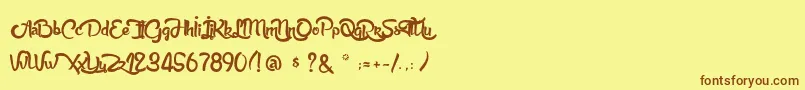 フォントAnabelleScript – 茶色の文字が黄色の背景にあります。