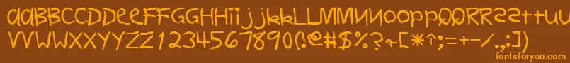 Czcionka FirstgradedisplaycapssskRegular – pomarańczowe czcionki na brązowym tle