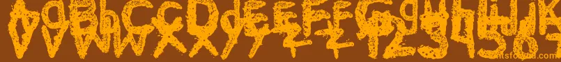 フォントKe$Hanimal2 – オレンジ色の文字が茶色の背景にあります。