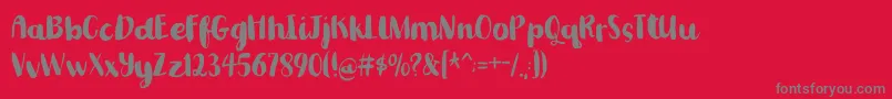 フォントRomkugledemo – 赤い背景に灰色の文字