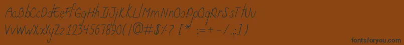 フォントCurzab – 黒い文字が茶色の背景にあります