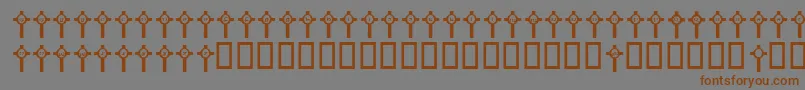 フォントJlrClonmacnoise – 茶色の文字が灰色の背景にあります。
