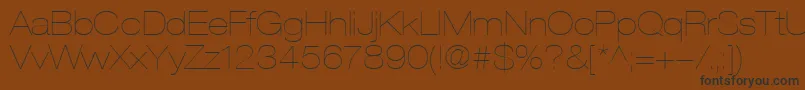 HelveticaLt23UltraLightExtended-fontti – mustat fontit ruskealla taustalla