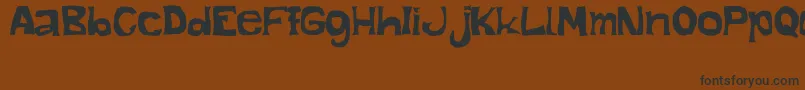 フォントManoAlzada – 黒い文字が茶色の背景にあります