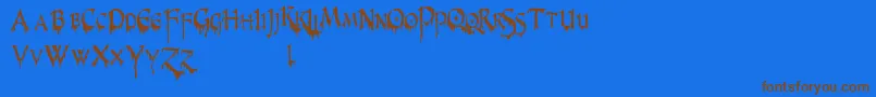 PrUncialCreepyNarrow-Schriftart – Braune Schriften auf blauem Hintergrund