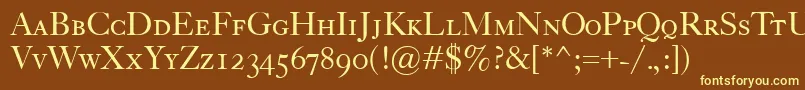 CaslonClassicoSc-fontti – keltaiset fontit ruskealla taustalla