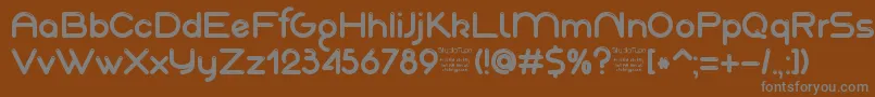 AkajuDemo-fontti – harmaat kirjasimet ruskealla taustalla
