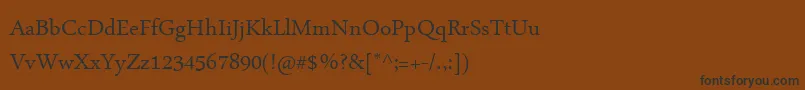 フォントArabicTypesetting – 黒い文字が茶色の背景にあります