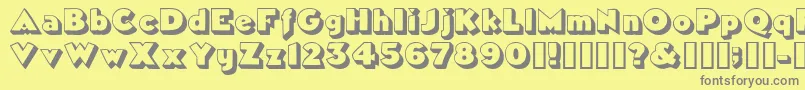 フォントTricorneoutlinesskBold – 黄色の背景に灰色の文字