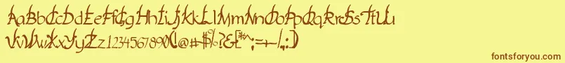 フォントYakap – 茶色の文字が黄色の背景にあります。