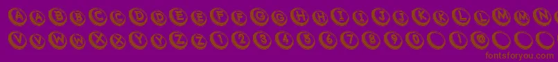 Czcionka Com – brązowe czcionki na fioletowym tle