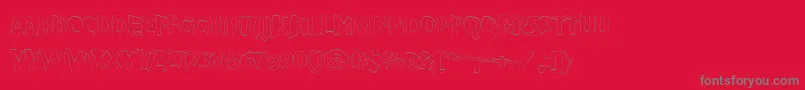 Czcionka VtcBadpaintOutline – szare czcionki na czerwonym tle