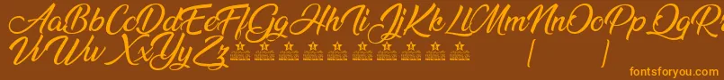 AnandaPersonalUse Font – Orange Fonts on Brown Background
