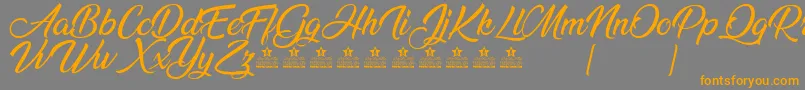 AnandaPersonalUse Font – Orange Fonts on Gray Background