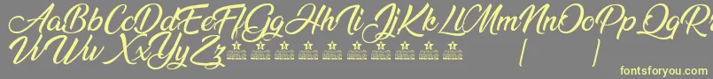 AnandaPersonalUse Font – Yellow Fonts on Gray Background