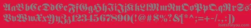Fetteunzfraktur-fontti – harmaat kirjasimet punaisella taustalla