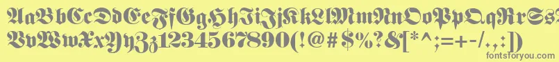 Fetteunzfraktur-fontti – harmaat kirjasimet keltaisella taustalla