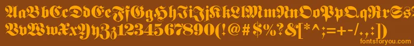 Fetteunzfraktur-fontti – oranssit fontit ruskealla taustalla