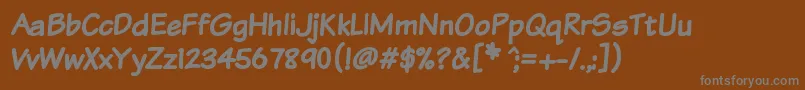 Komtxtb Font – Gray Fonts on Brown Background