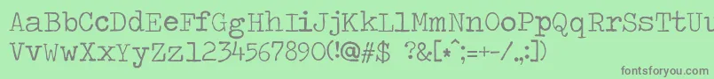 フォントTravelingtypewriter – 緑の背景に灰色の文字