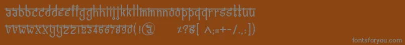 フォントBitlingvedasRegular – 茶色の背景に灰色の文字