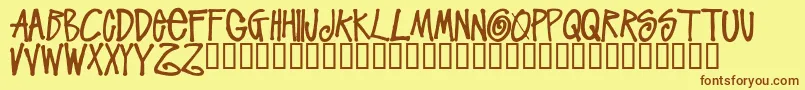 フォントStussyscriptRegular – 茶色の文字が黄色の背景にあります。