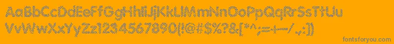 IrritateBrk-fontti – harmaat kirjasimet oranssilla taustalla