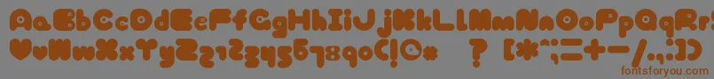 フォントTokyoHoneyChan – 茶色の文字が灰色の背景にあります。