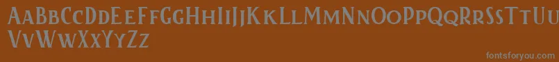 Kertayasafree-fontti – harmaat kirjasimet ruskealla taustalla