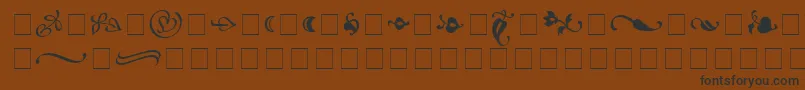 フォントAtlantixOrnamentsSsi – 黒い文字が茶色の背景にあります