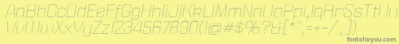 PoliticaXtLightItalic-fontti – harmaat kirjasimet keltaisella taustalla