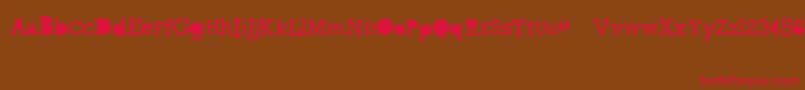 GycentiumGoespop-Schriftart – Rote Schriften auf braunem Hintergrund