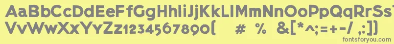 Lietzblockdemo-fontti – harmaat kirjasimet keltaisella taustalla