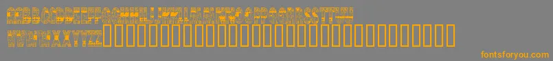 フォントBrinetextPattern – オレンジの文字は灰色の背景にあります。