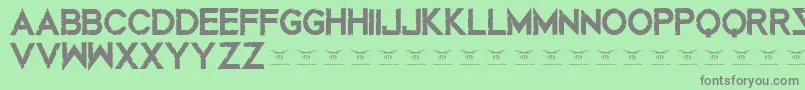 Mustafarreloaded-Schriftart – Graue Schriften auf grünem Hintergrund