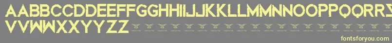 Mustafarreloaded-Schriftart – Gelbe Schriften auf grauem Hintergrund