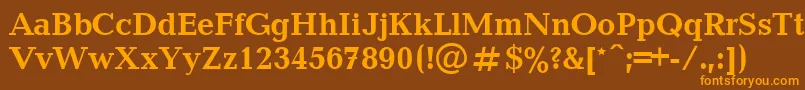 フォントUkrainianbalticaBold – オレンジ色の文字が茶色の背景にあります。