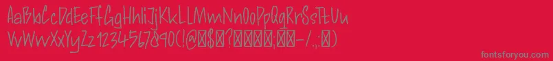 DkAndorraScript-fontti – harmaat kirjasimet punaisella taustalla