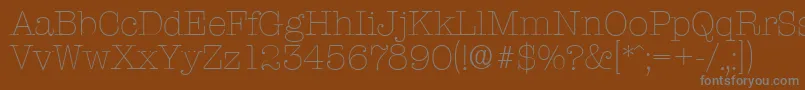 TypewriterserialXlightRegular-fontti – harmaat kirjasimet ruskealla taustalla