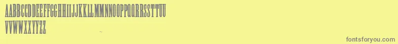AlycidonCondensed-fontti – harmaat kirjasimet keltaisella taustalla
