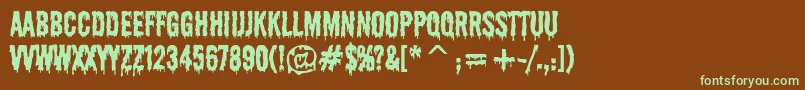 フォントShlop – 緑色の文字が茶色の背景にあります。