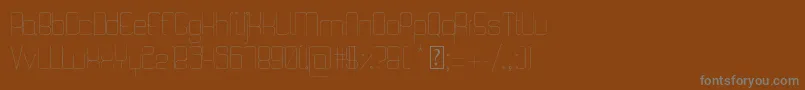 QuattroThin-fontti – harmaat kirjasimet ruskealla taustalla