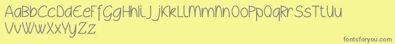 フォントWyllamdemo – 黄色の背景に灰色の文字