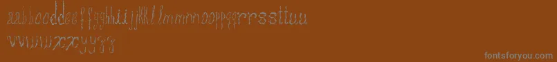 Шрифт Assperiments – серые шрифты на коричневом фоне
