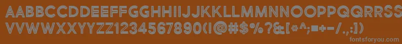 BmdMarketFreshInlineBoldAllCaps-fontti – harmaat kirjasimet ruskealla taustalla
