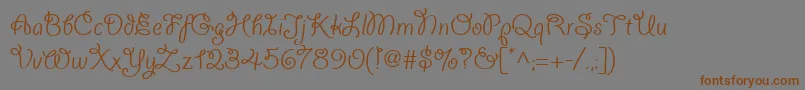 フォントGiddyupwebpro – 茶色の文字が灰色の背景にあります。