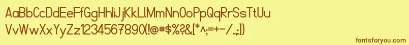 フォントFibelNord – 茶色の文字が黄色の背景にあります。